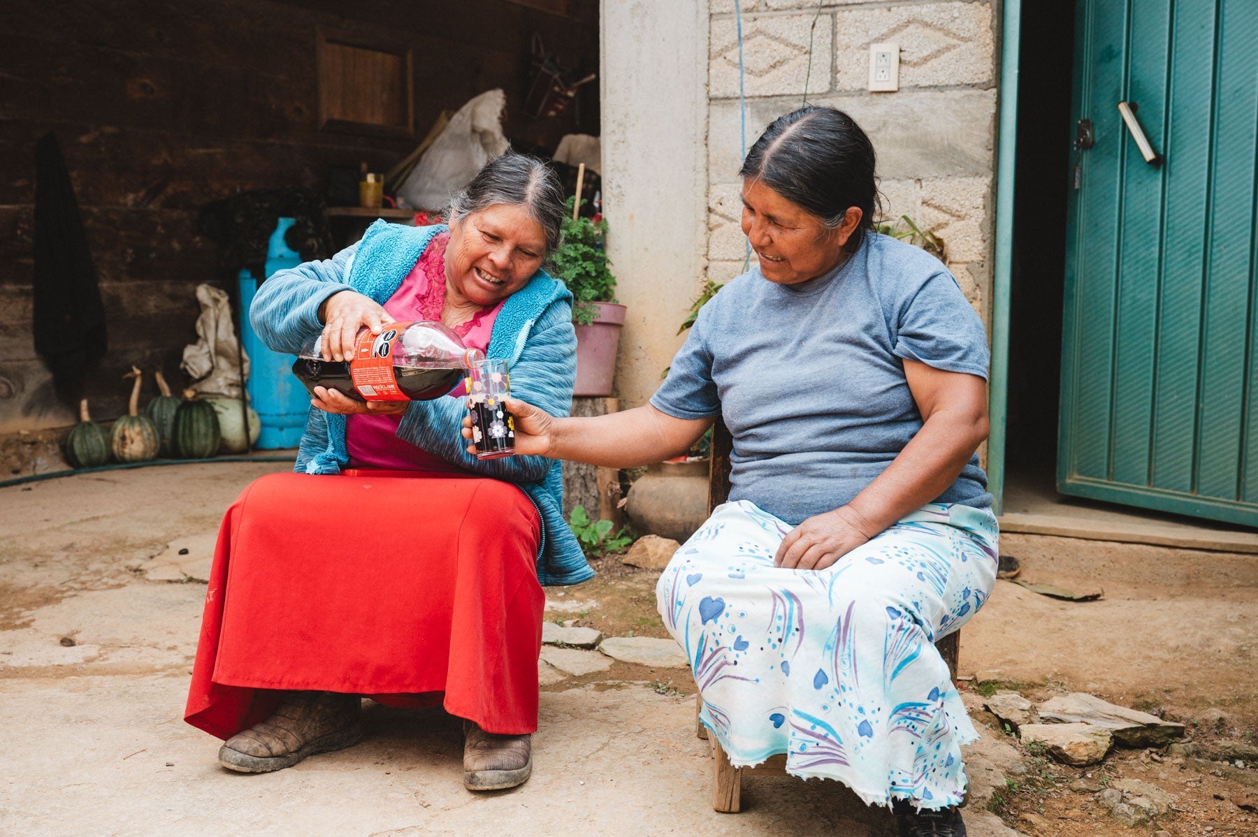 Two indigenous Mexican woman sharing a coca cola