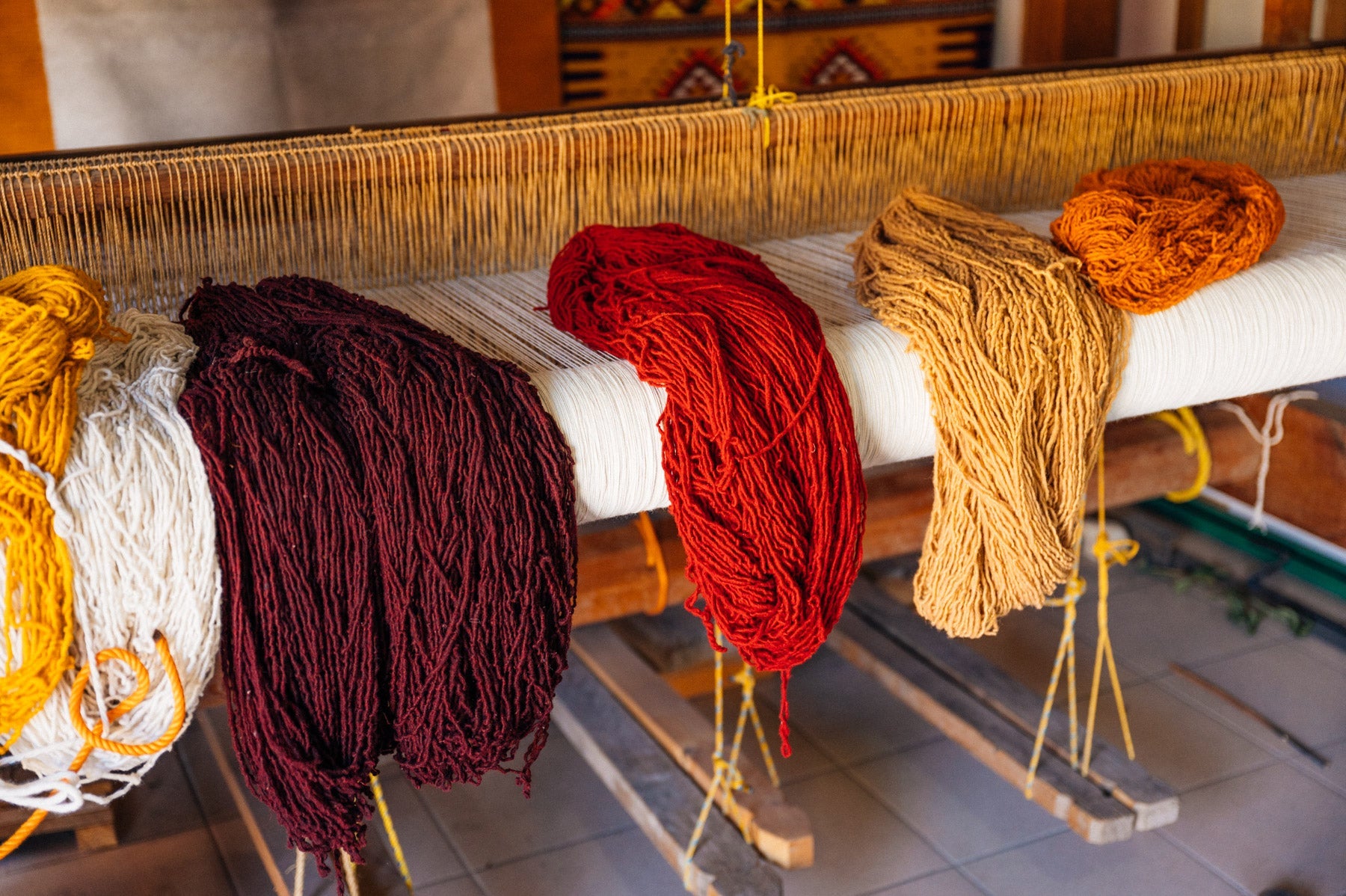 Spools of freshly dyed natural wool sitting on the loom in Teotitlan Del Valle