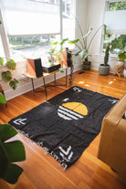 black solar handwoven mexican blanket on the floor