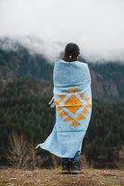 Woman wrapped in blue handwoven mexican blanket