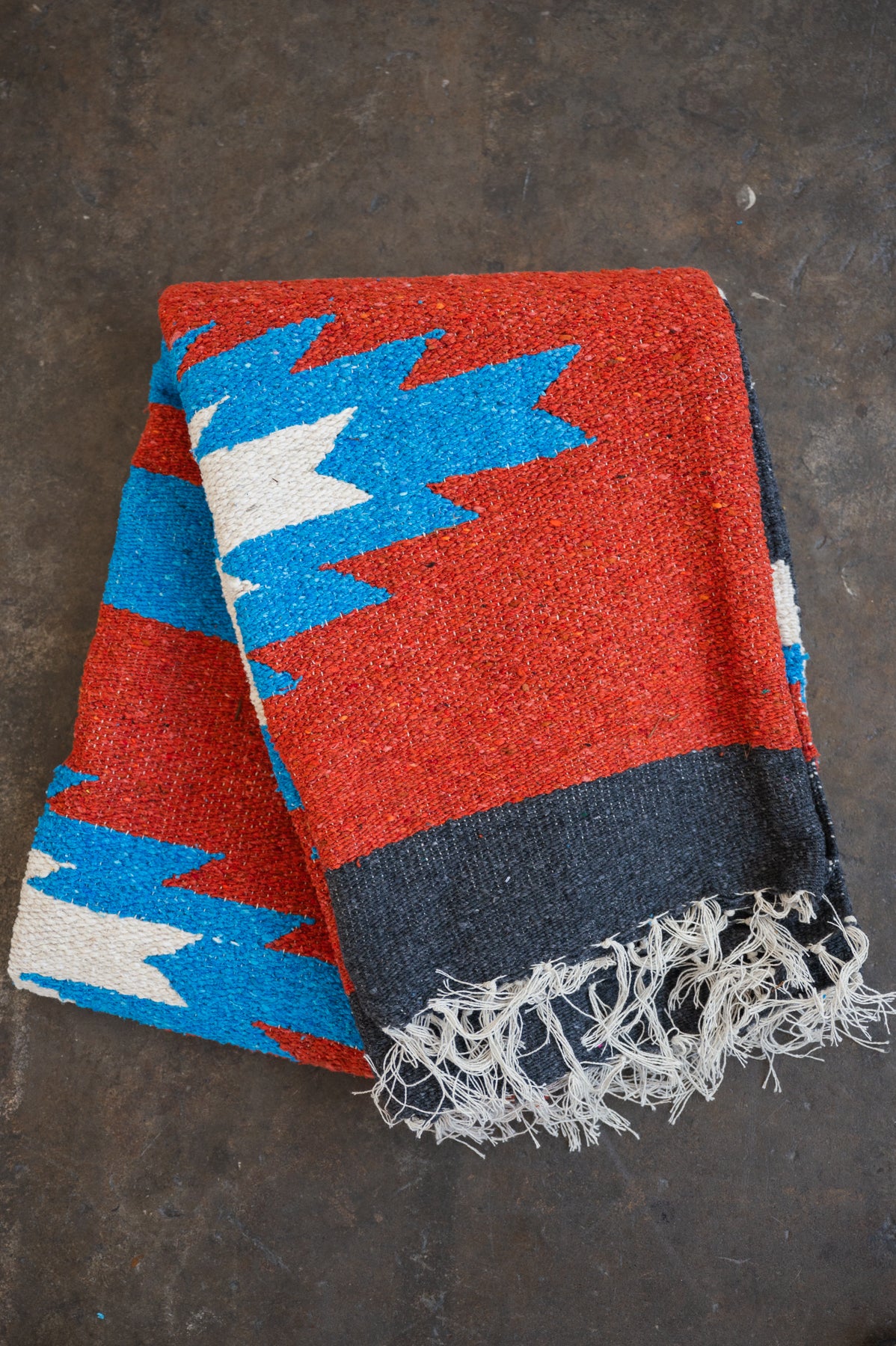 Red blue and black southwestern diamond handwoven blanket folded