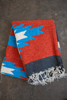 Red blue and black southwestern diamond handwoven blanket folded