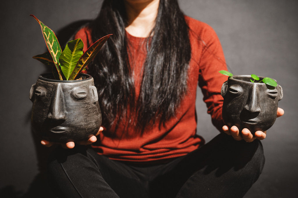 Woman holding handmade barro negro planters