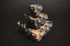 Handmade barro negro clay carita mezcalero cups from Oaxaca