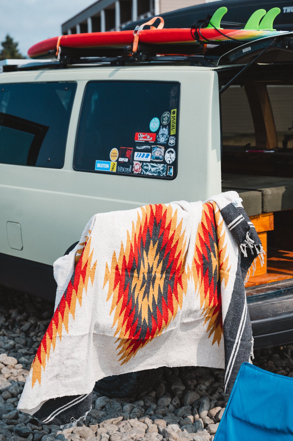 red and black southwest diamond sarape sitting on surf van door