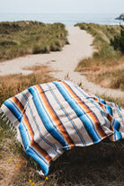 Saltillo blanket laying on rock at sand dunes