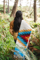 handwoven southwestern diamond sarape being worn by girl in forest