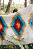 handwoven southwestern diamond sarape being worn by girl in forest