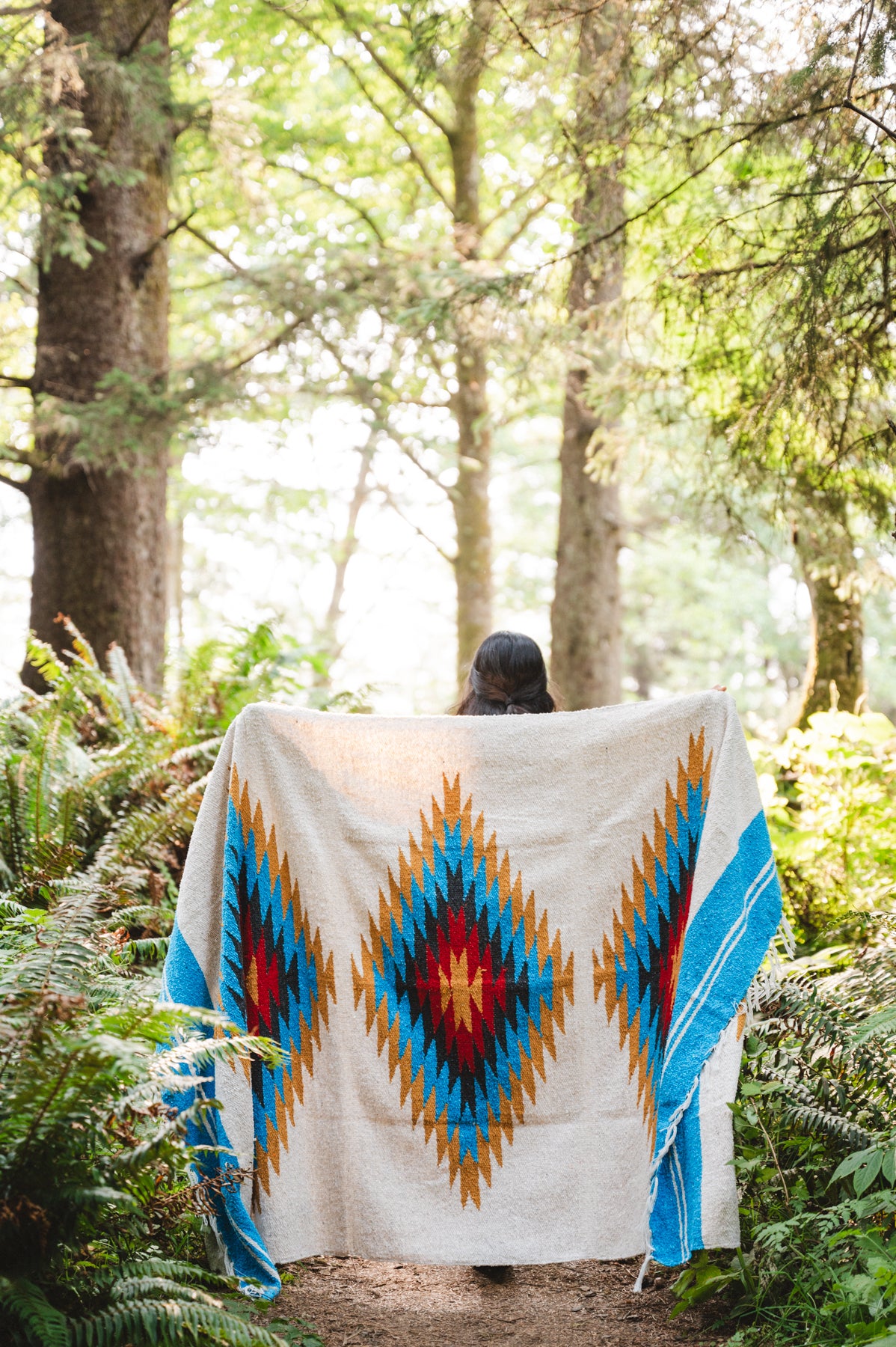 handwoven southwestern diamond sarape being worn by girl in forest