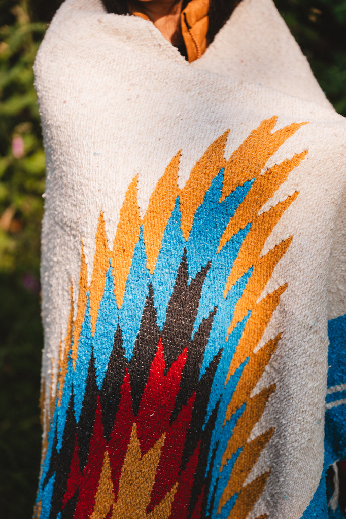 handwoven southwestern diamond sarape being worn by girl in forest