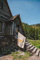 Tan solar blanket in front of cabin on the mountain