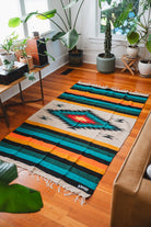 green and orange diamond blanket on the floor