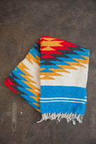 Red and yellow and blue southwestern diamond handwoven blanket folded