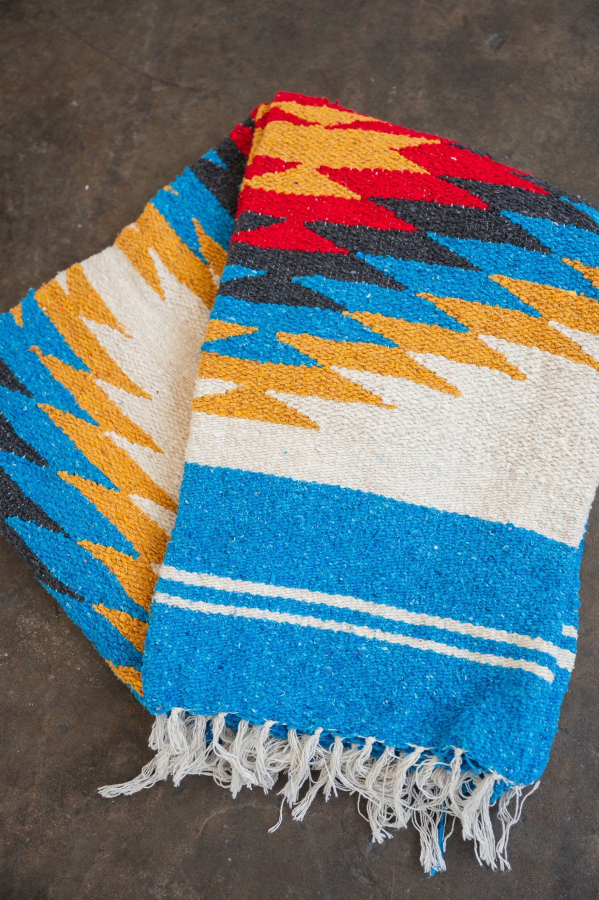 Red and yellow and blue southwestern diamond handwoven blanket folded