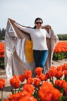 lady holding tan sun blanket