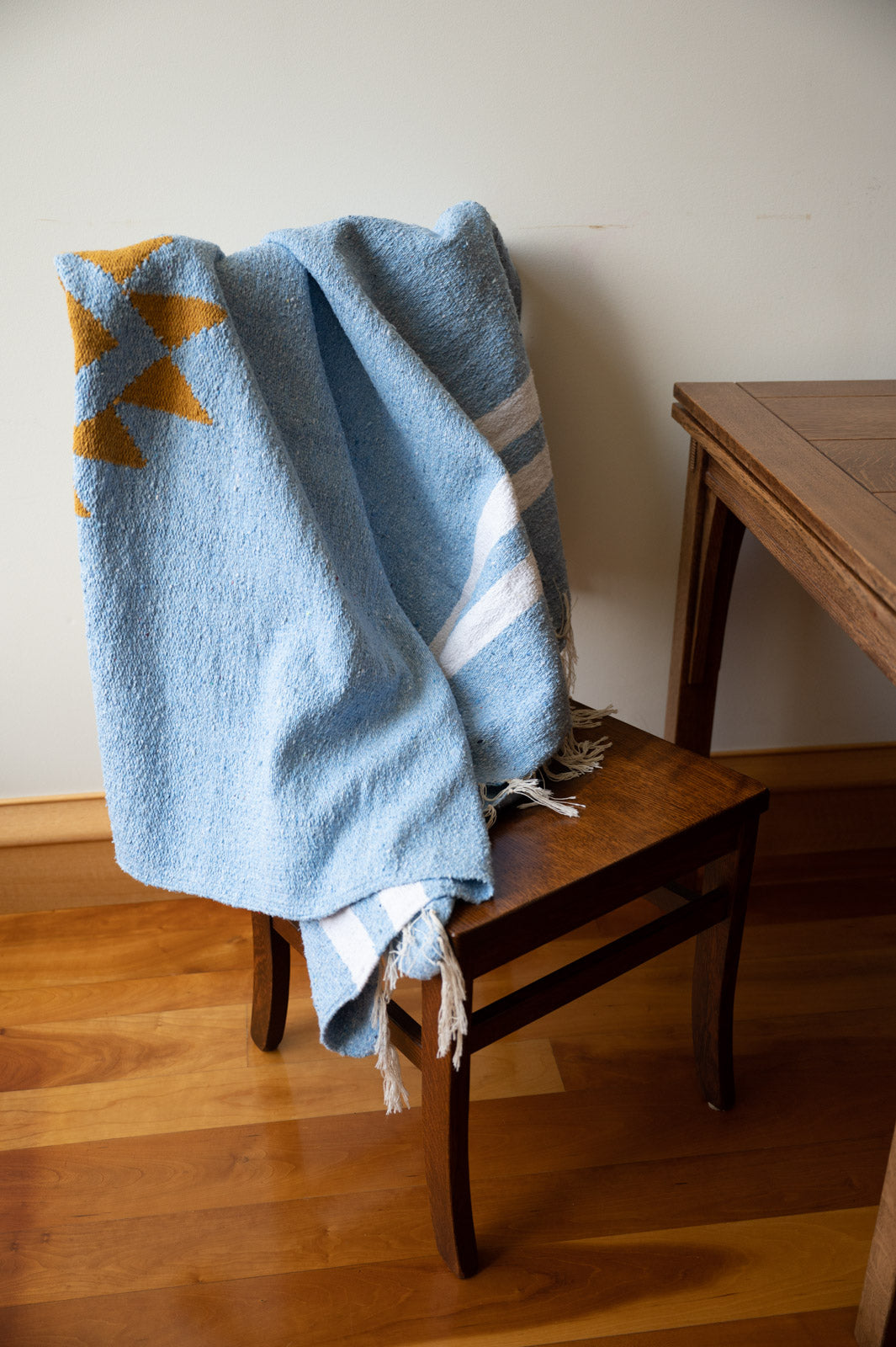 blue mexican blanket on a chair