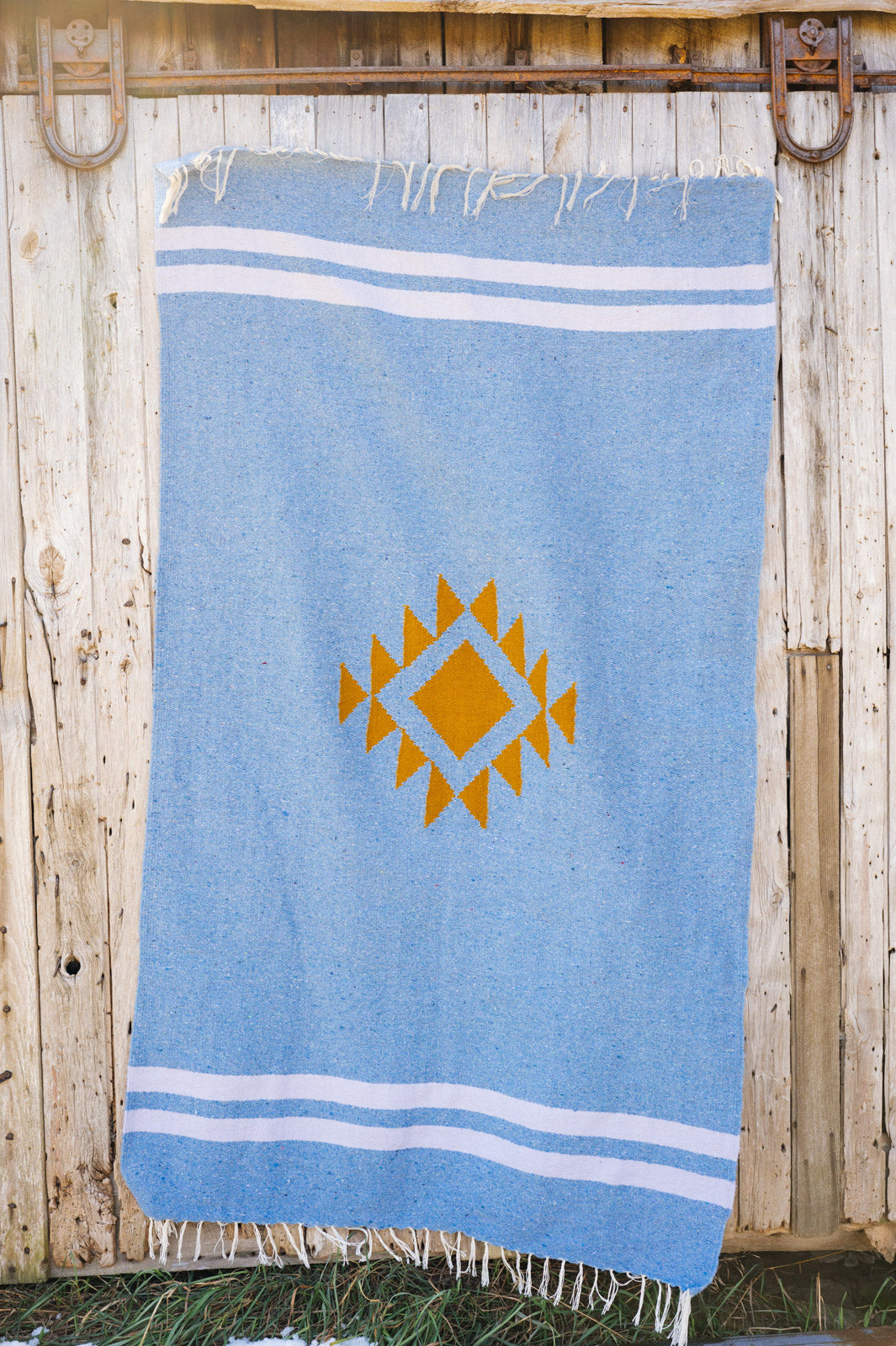 Blue mexican blanket on a barn door