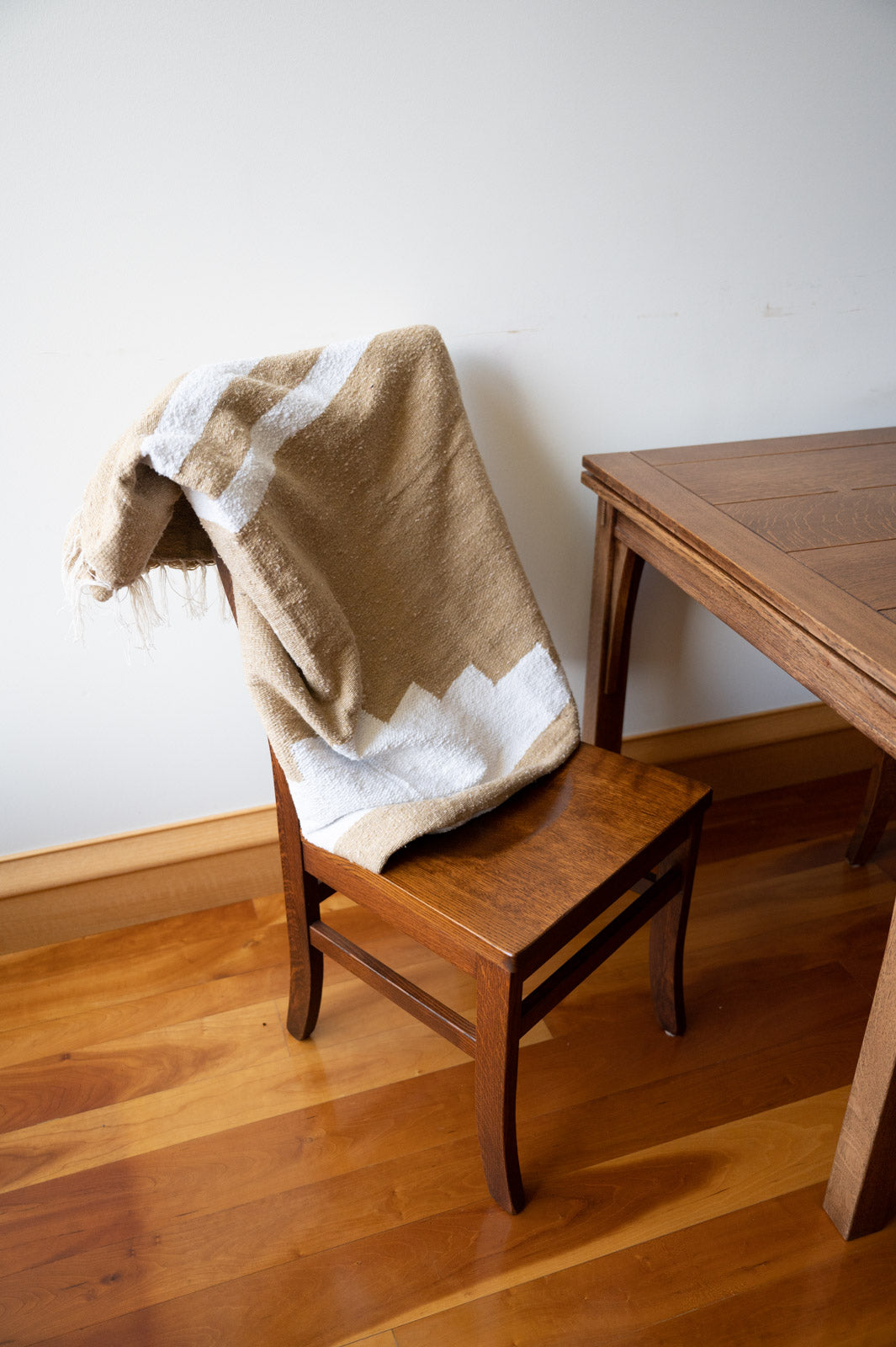 Tan mexican blanket on a chair